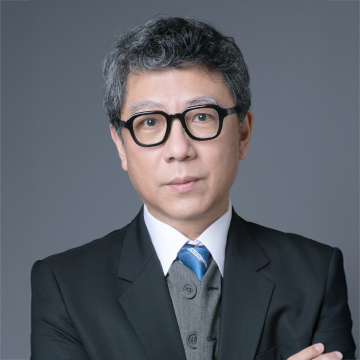 Man in suit and glasses with arms crossed, professional portrait
