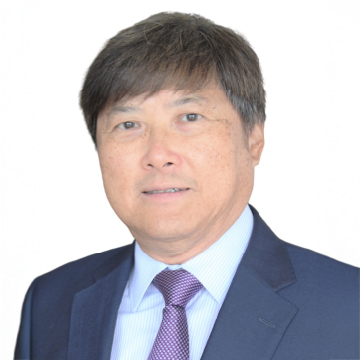 Portrait of a man in business attire with dark suit and patterned tie.