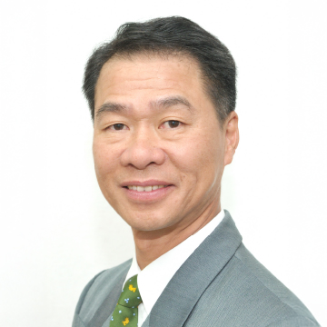 Professional portrait of a smiling man in suit and patterned tie.