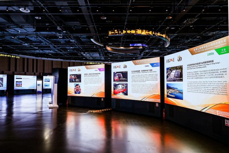 Exhibition hall with large informational panels showcasing Hong Kong's engineering legacy from 1980s to 1990s.