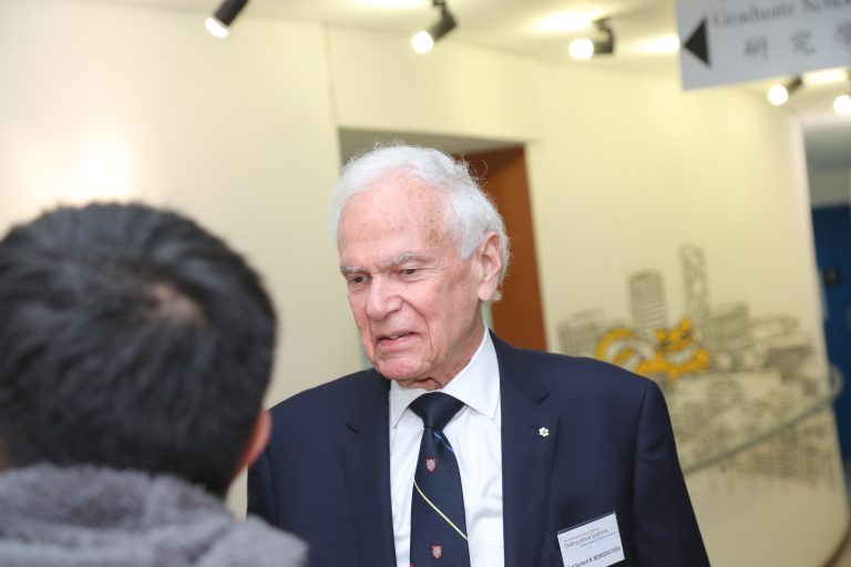 Man in suit talking at event