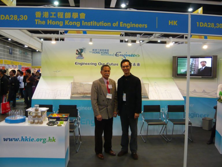 Two men posing at The Hong Kong Institution of Engineers exhibition booth.