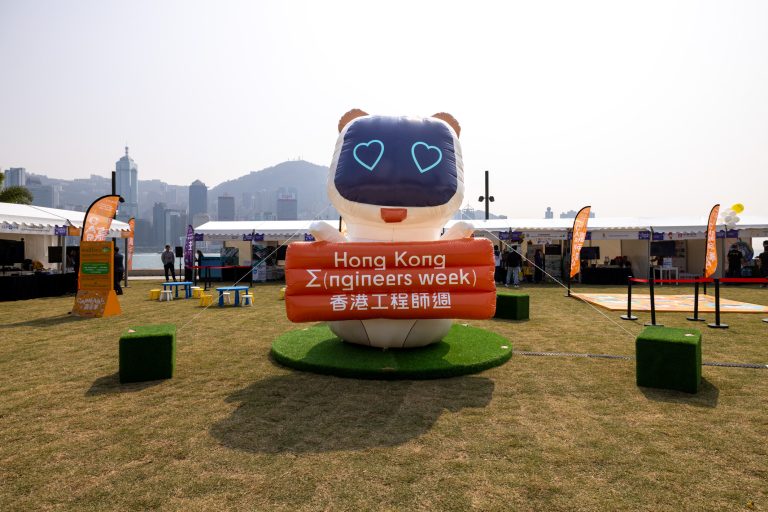 Inflatable mascot holding sign for Hong Kong Engineers Week event outdoors.