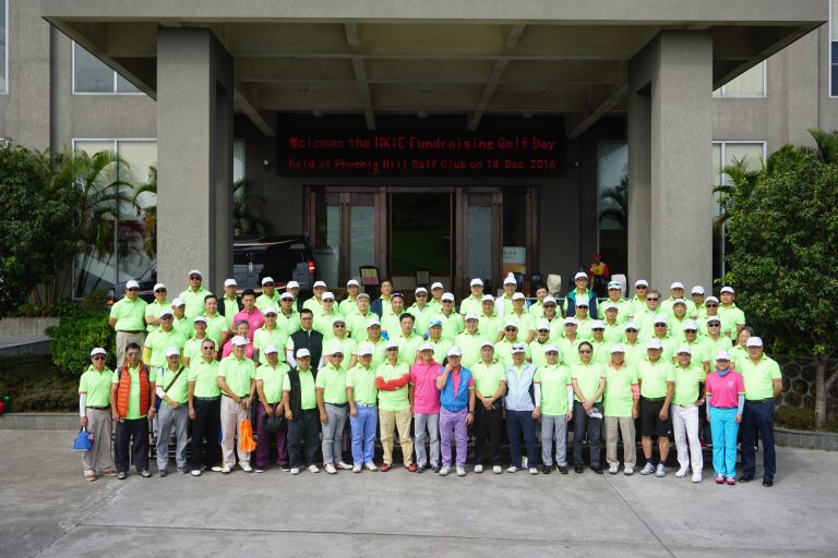 Group photo of golfers in bright green shirts at fundraising event at Phoenix Mill Golf Club.