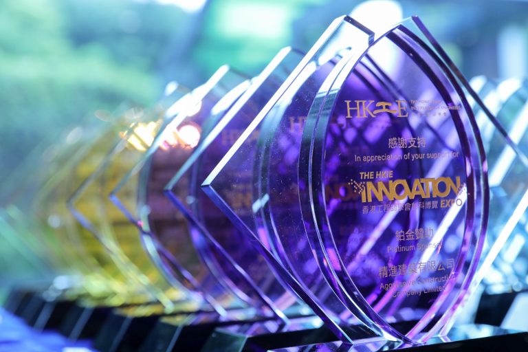 Platinum sponsor award for HKIE Innovation Expo displayed in glass trophy.