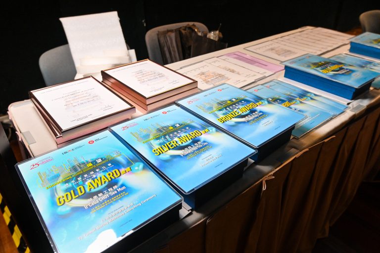 Table displays engineering awards including gold, silver, and bronze prize certificates.