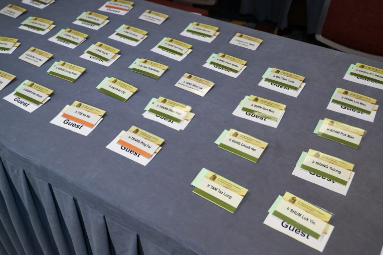 Name tags for attendees at a conference arranged on a table.