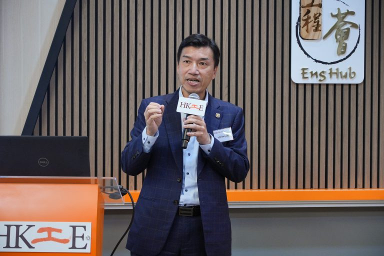 Man speaking into microphone at podium with HKIE and EnsHub logos.