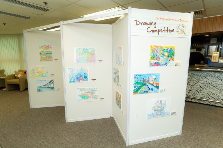 Children's drawings displayed on exhibition panels for a Hong Kong engineering drawing competition.