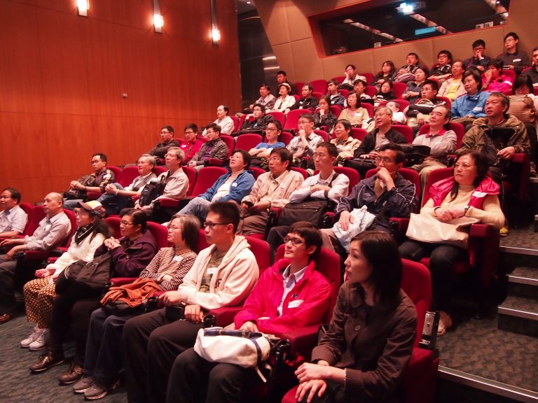 Audience seated in theater watching performance