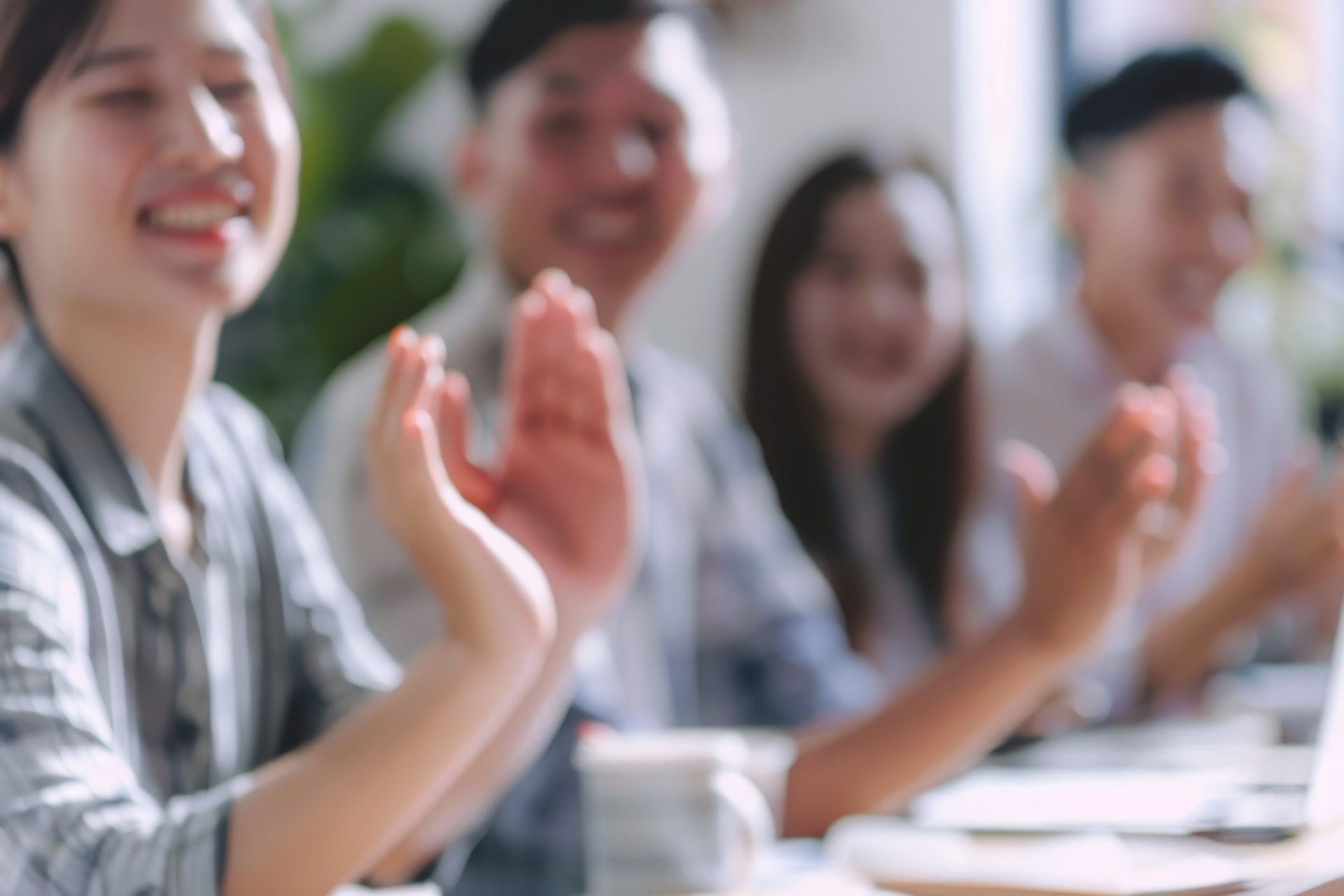 People clapping and smiling after a business seminar.