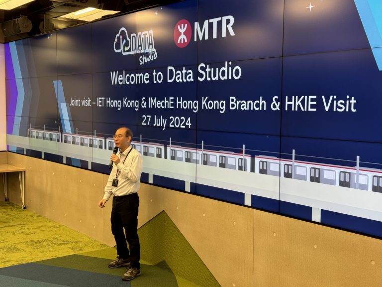 Man speaking into microphone in front of MTR Data Studio welcome screen.