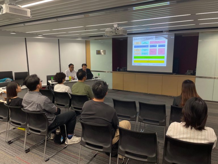 Audience attending a presentation on routes to corporate membership.